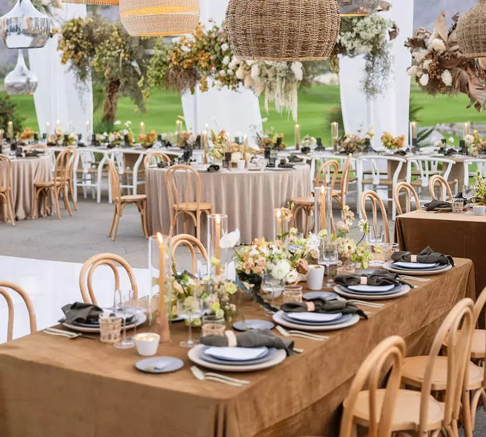 outdoor event with several rectangular and circular tables