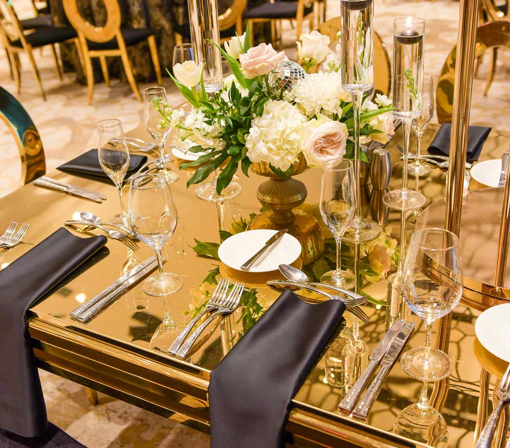 close up of gold table set for event