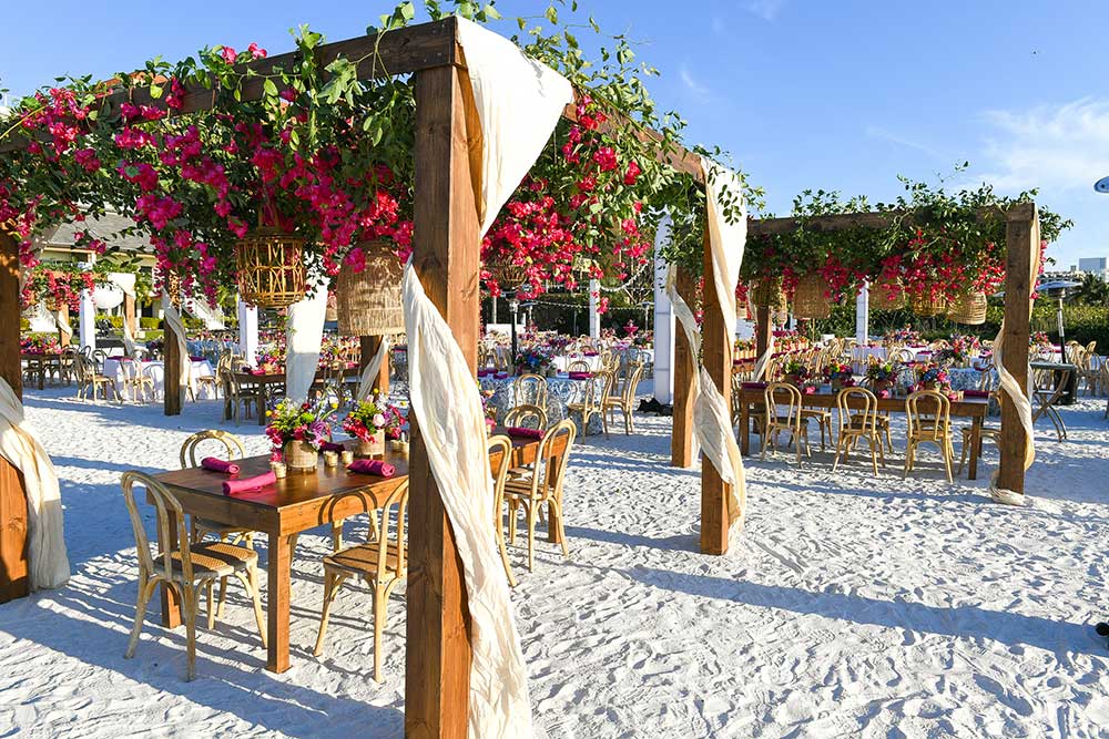 event with tables and pergolas covered in flowers