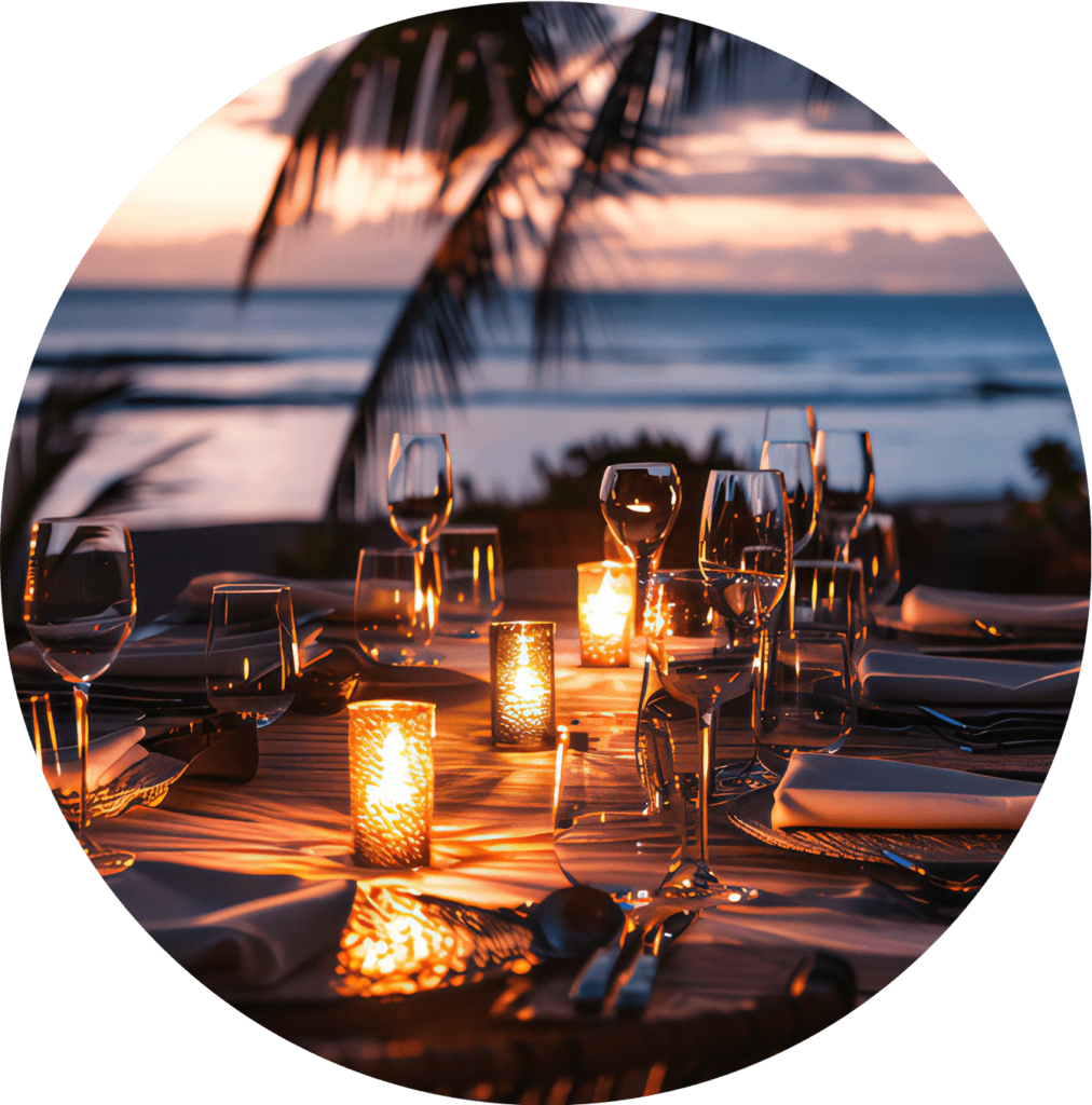 table with votive candles lit with the ocean in the background
